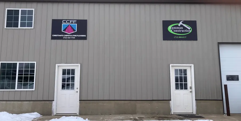 The Christian's Carpets & Fine Flooring sign and phone number on the showroom building at 102 Maple St, Mapleton