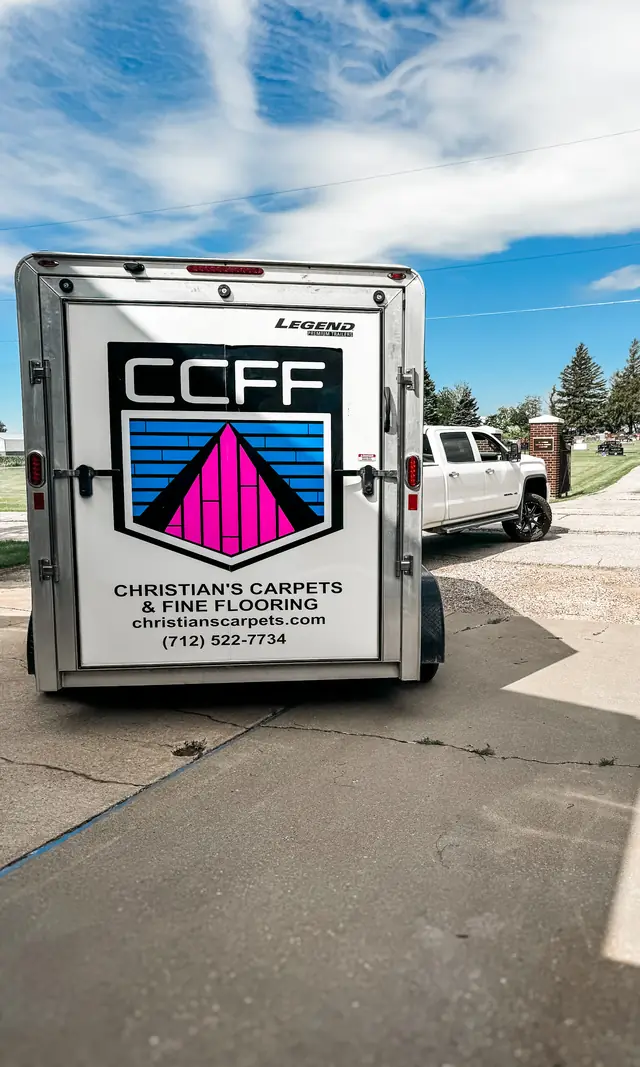 The Christian's Carpets trailer with the CCFF crest and phone number on its rear doors