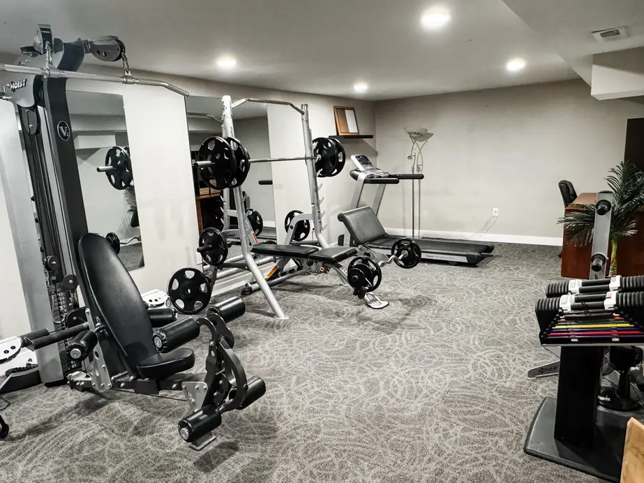 Basement home gym with patterned carpet installed by Christian's Carpets