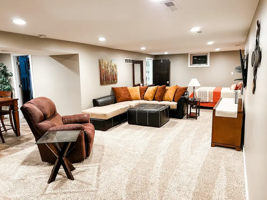 Finished basement family room with new light carpet installed by Christian's Carpets