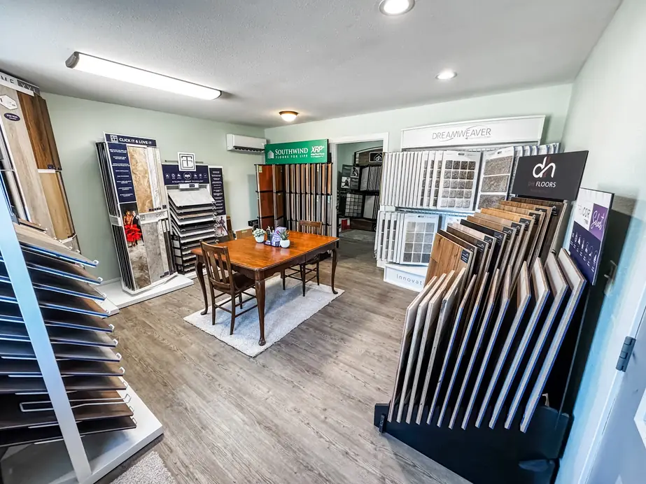 Inside the Christian's Carpets showroom in Mapleton: plank racks, carpet sample walls and a consultation table