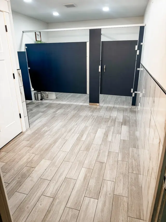 Commercial restroom with wood-look tile flooring