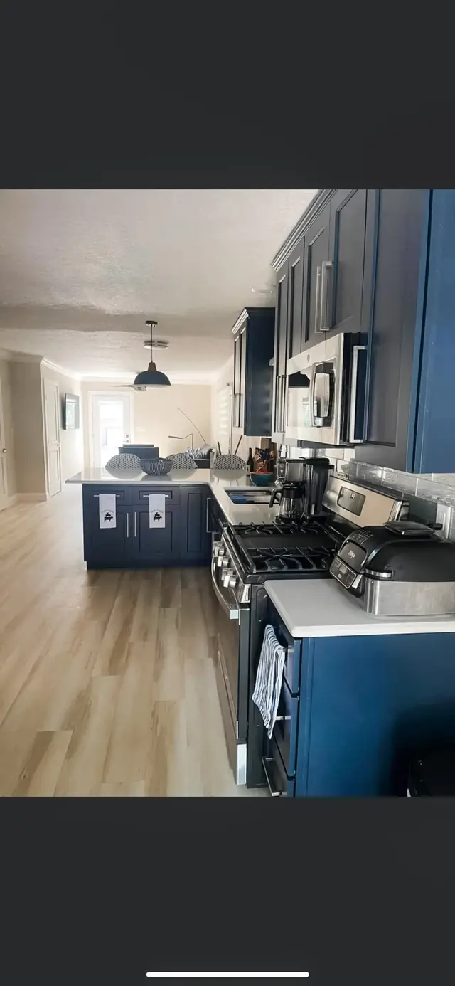 Kitchen with blue cabinets and wood-look LVP flooring